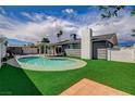 A beautiful backyard with a pool, green grass, and an exterior view of the home at , Las Vegas, NV 89145