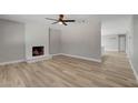 Spacious living room featuring a cozy white brick fireplace and neutral paint at , Las Vegas, NV 89145