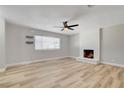 Inviting living room with brick fireplace, sleek ceiling fan, and ample natural light at , Las Vegas, NV 89145