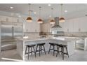 Modern kitchen with stainless steel appliances and a large island with bar stool seating at 12199 Canyon Sunset St, Las Vegas, NV 89138