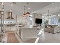 Bright, open-concept living space with a marble accent wall and floor-to-ceiling windows at 12199 Canyon Sunset St, Las Vegas, NV 89138