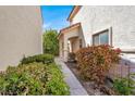 Home exterior showcasing desert landscaping with a walkway that leads to the front door at 1405 Sycamore Spring Ct, Las Vegas, NV 89128