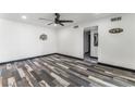 Bright living room featuring contemporary ceiling fan, neutral walls and striking weathered wood-style flooring at 1405 Vegas Valley Dr # 236, Las Vegas, NV 89169