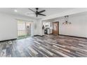 Bright living room with sliding door access to balcony, contemporary ceiling fan and rustic weathered wood flooring at 1405 Vegas Valley Dr # 236, Las Vegas, NV 89169