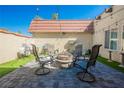 Outdoor living in an outdoor patio with pavers, synthetic grass, and fire pit at 1709 Chapman Dr, Las Vegas, NV 89104