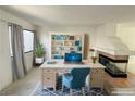 Inviting home office space with built-in shelving, fireplace, and comfortable work area at 2282 Camel Mesa Dr, Laughlin, NV 89029