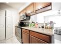 Updated kitchen featuring light countertops, white tile floors, and stainless steel appliances at 3135 S Mojave Rd # 241, Las Vegas, NV 89121