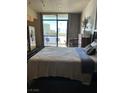 Bright bedroom with a view of the city, stainless steel fridge, and table at 353 E Bonneville Ave # 631, Las Vegas, NV 89101