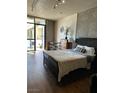 Well-lit bedroom with a view, hardwood floors, and modern decor at 353 E Bonneville Ave # 631, Las Vegas, NV 89101