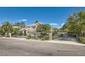 Charming two-story home with a well-manicured lawn, secure black metal gate, and beautiful palm trees at 3560 Five Pennies Ln, Las Vegas, NV 89120
