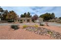 Expansive front yard featuring desert landscaping, mature trees and attractive curb appeal at 3580 Unicorn Ave, Pahrump, NV 89048