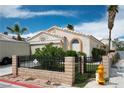 Attractive single-story home with a well-maintained yard, framed by a black metal fence at 3934 Sir Payne Ct, Las Vegas, NV 89104