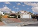 Charming single-Gathering home with a two-car garage, mature trees, and a well-maintained front yard at 5010 Mick Pl, Las Vegas, NV 89103