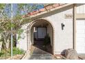 Inviting front entrance with an arched walkway, a double door, and desert landscaping at 5010 Mick Pl, Las Vegas, NV 89103