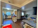 Open-concept living room with hardwood floors, connecting the kitchen to the living area at 5250 S Rainbow Blvd # 1131, Las Vegas, NV 89118