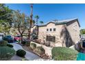 Charming exterior view featuring a private patio with mature trees and green bushes at 5253 Westwind Rd, Las Vegas, NV 89118