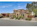 Elegant two-story house showcasing a three-car garage, landscaped front yard and beautiful architecture at 549 Via Balizan Ave, Las Vegas, NV 89123