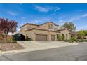 Beautiful two-story home with a three-car garage, gated driveway and meticulous front yard landscaping at 549 Via Balizan Ave, Las Vegas, NV 89123