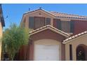 Close up of a two story home with well maintained tile roofing, shutters and desert landscaping at 5518 Ovando Way, Las Vegas, NV 89122