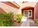 Inviting front entrance with landscaped bushes and a walkway leading to the front door at 5518 Ovando Way, Las Vegas, NV 89122