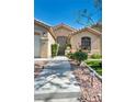 Well-maintained home featuring a beautiful walkway and desert landscaping leading to the inviting front entrance at 5578 River Highlands Pl, Las Vegas, NV 89122
