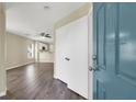 The entryway has gray wood floors and leads to an open living room and kitchen at 5783 Sol Vista Ave, Las Vegas, NV 89122