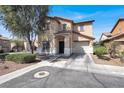 Two-story home features a tile roof, desert landscaping, and two-car garage at 5783 Sol Vista Ave, Las Vegas, NV 89122