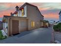 Exterior view of the home highlighting the backyard with a covered patio, lush landscaping, and a privacy fence at 5845 Killala Ct, Las Vegas, NV 89110