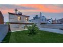 Spacious backyard with well-maintained lawn, mature trees, a brick privacy wall, and a charming residential exterior at 5845 Killala Ct, Las Vegas, NV 89110