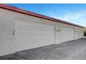 Spacious garages with a clean exterior and ample parking space at 609 Greenbriar Townhouse Way, Las Vegas, NV 89121