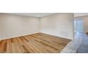 Bright living room with new laminate floors and fresh, neutral paint at 609 Greenbriar Townhouse Way, Las Vegas, NV 89121