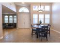 Inviting dining area featuring a round table, hardwood flooring, and direct access to the living room at 6493 Yellow Bells Ct, Las Vegas, NV 89131