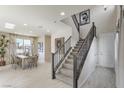 Bright entryway features a staircase, and a dining area with ample natural light from large windows at 8412 Sycamore Creek St, Las Vegas, NV 89113