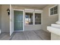 Inviting entryway with a green front door, large windows, and neutral stucco walls at 8500 Gull Dr, Las Vegas, NV 89134