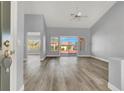 Open living room featuring modern gray walls, updated floors, and backyard access at 8500 Gull Dr, Las Vegas, NV 89134