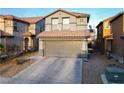 Two-story home with a two-car garage, tile roof, and desert landscaping offers curb appeal and modern living at 8532 Caddy Corner St, Las Vegas, NV 89139