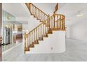 Bright entryway featuring a classic wooden staircase and marble flooring at 8600 Soneto Ln, Las Vegas, NV 89117