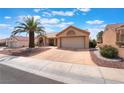 Attractive single-story home with a low-maintenance yard and attached two-car garage, presenting a clean and tidy appearance at 9305 Quail Ridge Dr, Las Vegas, NV 89134
