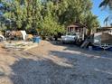 An exterior view of a home featuring a gravel area, a white pickup truck, and miscellaneous stored items at 2510 Sunrise St, Las Vegas, NV 89101