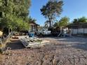 An exterior view of a home featuring a gravel area, a white pickup truck, and miscellaneous stored items at 2510 Sunrise St, Las Vegas, NV 89101