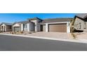 Street view of a single-story house with stone details, landscaping, and a two-car garage at 352 Tigullio Ave, Henderson, NV 89011