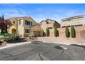 Inviting two-story home with tan stucco, shutters, desert landscaping, and a two car garage at 10437 Walworth Ave, Las Vegas, NV 89166