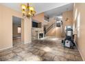 Spacious living room showcasing a fireplace, staircase, and an open floor plan at 10437 Walworth Ave, Las Vegas, NV 89166
