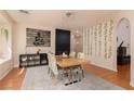 The dining room features a large table, modern art, and hardwood floors at 2691 Rimpacific Cir, Las Vegas, NV 89146