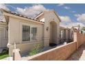 Charming front yard, desert landscaping, and arched entryway to the front door at 2691 Rimpacific Cir, Las Vegas, NV 89146