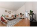 Bright living room with vaulted ceilings, hardwood floors, neutral paint, stylish decor, and lots of natural light at 2691 Rimpacific Cir, Las Vegas, NV 89146