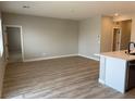 Bright living room with wood-look flooring and neutral walls, with an open concept at 3232 Walker River St, North Las Vegas, NV 89032