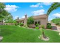 Expansive backyard with lush green lawn, mature trees and landscaping, offering a serene outdoor space at 4722 Blue Mesa Way, Las Vegas, NV 89129