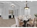 Bright dining room featuring a marble table, decorative lighting, and stylish modern furnishings at 4722 Blue Mesa Way, Las Vegas, NV 89129