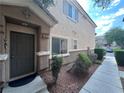 Exterior view of home featuring a neatly landscaped front yard with walkway leading to the front door at 6080 Golden Corral Trl # 103, Henderson, NV 89011
